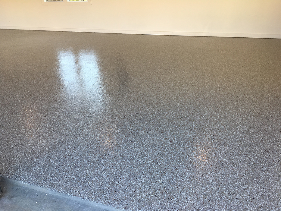 Freshly installed gray flake epoxy garage floor