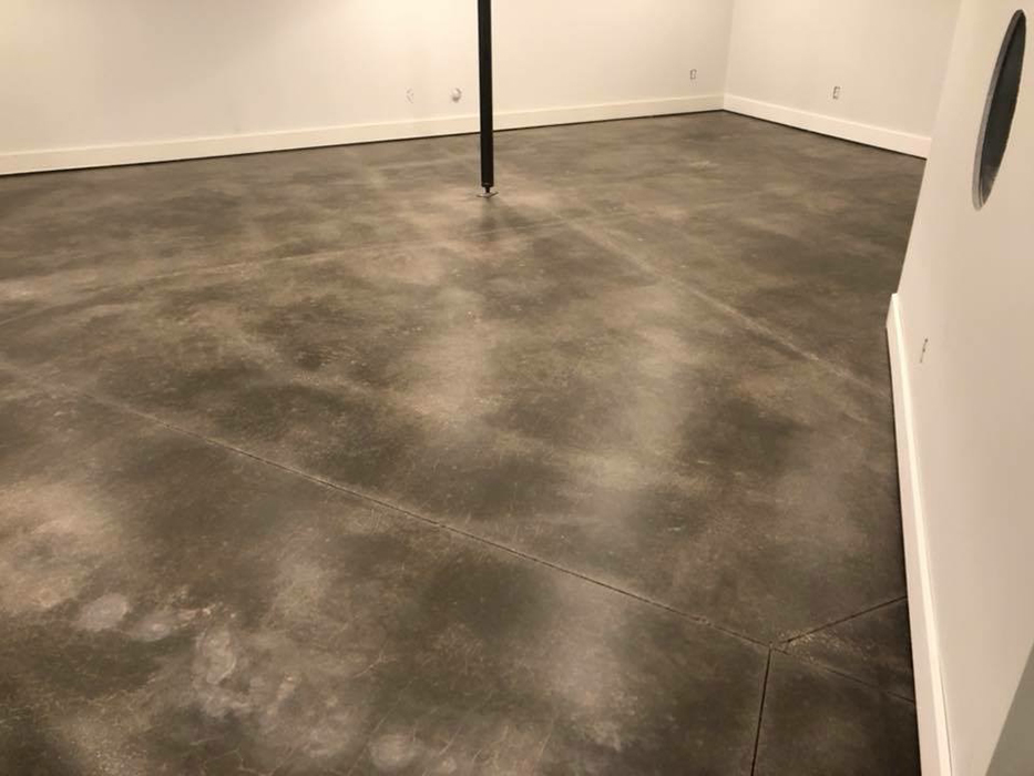 Stained concrete basement floor finished by Stampcrete